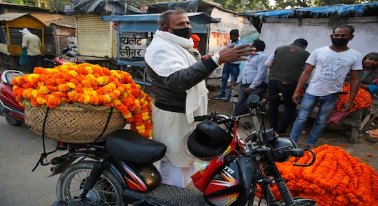 Vendors sell Marigold flowers at a wholesale flower market during Ashtami, eighth day of Navratri festival in Prayagraj, India, Wednesday, April 1, 2020. Hindus celebrate Navaratri, or the festival of nine nights, with three days each devoted to the worship of Durga, the goddess of valor, Lakshmi, the goddess of wealth, and Saraswati, the goddess of knowledge. (AP Photo/Rajesh Kumar Singh)