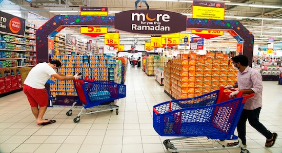 In this Sunday, April 19, 2020 photo, shoppers wearing face masks and gloves amid the coronavirus pandemic pass by a Ramadan display at a Carrefour supermarket in Dubai, United Arab Emirates. As Ramadan begins with the new moon later this week, Muslims all around the world are trying to work out how to maintain the many cherished rituals of Islam’s holiest month as much as possible -- without further spreading the outbreak. Many of those traditions are now impossible as authorities try to clamp down against the pandemic. (AP Photo/Jon Gambrell)