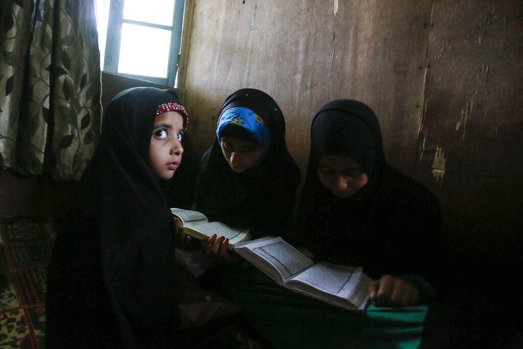Kashmiri Muslim children attend recitation classes of the holy Quran on the first day of the fasting month of Ramadan in Srinagar, May 7, 2019. (AP Photo/Mukhtar Khan)