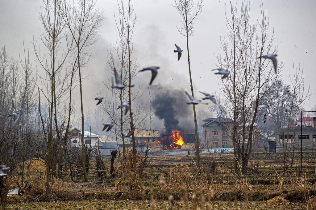 Flames and smoke billow from a residential building where militants are suspected to have taken refuge during a gun battle in Pulwama, south of Srinagar, Feb. 18, 2019. (AP Photo/Dar Yasin)