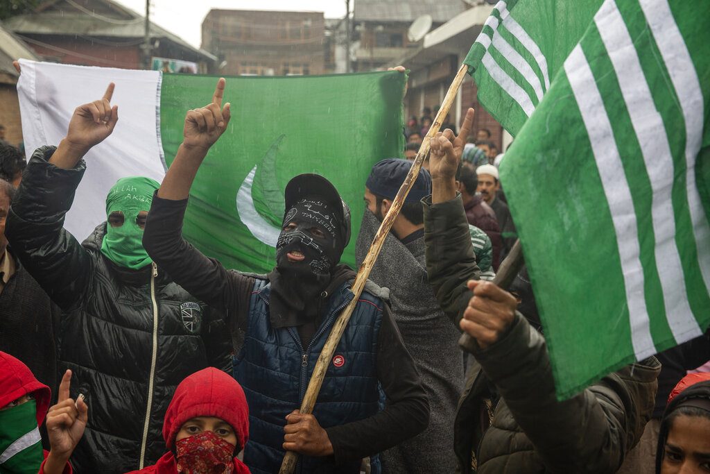 Masked Kashmiris shout slogans during a protest after Friday prayers on the outskirts of Srinagar, Oct. 4, 2019. (AP Photo/Dar Yasin)
