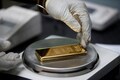 Gold holds steady, tracks dollar as election caution kicks in