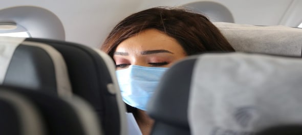 WHO backs face mask wearing on long flights as new Omicron variant spreads