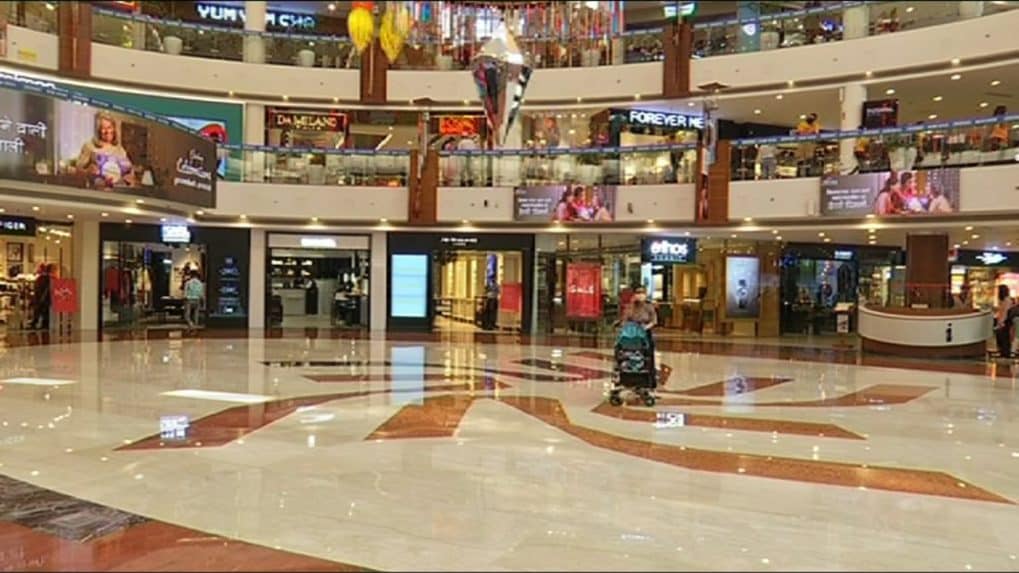 India - Delhi - A man walks through the DLF Emporio Mall