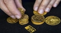 Gold dips after promising China data; set for weekly rise