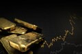 Gold drops to near 2-week low as stocks and dollar rise