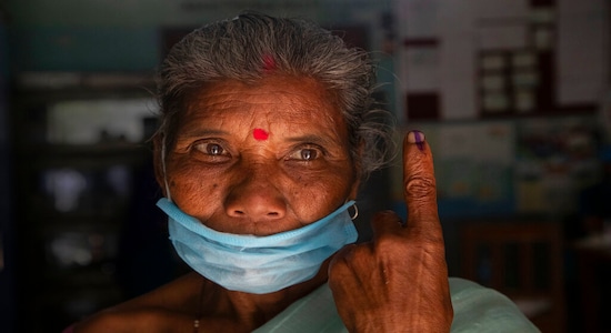 FILE: An elderly displays the indelible ink on her finger after casting her vote at a polling center during the first phase of state elections(AP Photo/Anupam Nath)