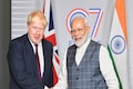 London Eye: Boris Johnson reaches for some Indian fruits