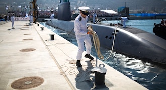 No.8 | Country: Israel | Total Nuclear Warheads as of 2021: 90 | Per cent of all nuclear warheads in the world: 0.69% | An Israeli naval officer holds the mooring rope of INS Tanin, a Dolphin AIP class submarine (Image: Reuters)