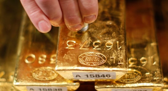 An employee of Deutsche Bundesbank tests a gold bar with an ultrasonic appliance during a news conference in Frankfurt Germany (Image: Reuters)