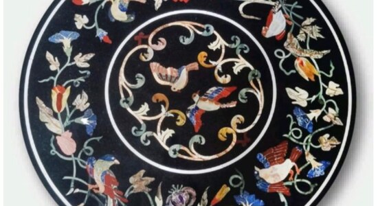 PM Modi gifted Marble Inlay table top to Italy’s PM Pietra dura or Marble inlay has its origins in Opus sectile- a form of pietra dura popularized in the ancient and medieval Roman world where materials were cut and inlaid into walls and floors to make a picture or pattern. This marble table top with Inlay work has its origin in Agra of Taj Mahal fame, This particular table top is made of semi precious stones with gradients in their colour, making it very similar to Italian marble inlay work. Stones with colour gradient are harder to place, but make the inlay more realistic. The delicate process involves cutting and engraving of semi-precious stones on marble manually. To start with, a pre-defined pattern e.g., a floral design or a geometrical design, is engraved on the marble item. Small pieces of different semi-precious stones are then cut delicately. These small pieces are then slipped into grooves, making the simple marble item a beautiful and colourful masterpiece of art. PM Modi gifted Marble Inlay table top to Italy’s PM Pietra dura or Marble inlay has its origins in Opus sectile- a form of pietra dura popularized in the ancient and medieval Roman world where materials were cut and inlaid into walls and floors to make a picture or pattern. This marble table top with Inlay work has its origin in Agra of Taj Mahal fame, This particular table top is made of semi precious stones with gradients in their colour, making it very similar to Italian marble inlay work. Stones with colour gradient are harder to place, but make the inlay more realistic. The delicate process involves cutting and engraving of semi-precious stones on marble manually. To start with, a pre-defined pattern e.g., a floral design or a geometrical design, is engraved on the marble item. Small pieces of different semi-precious stones are then cut delicately. These small pieces are then slipped into grooves, making the simple marble item a beautiful and colourful masterpiece of art.