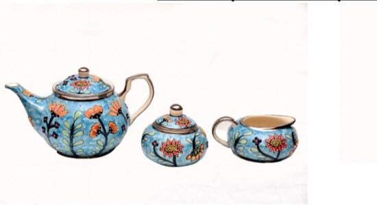 PM Modi gifted Platinum painted hand painted Tea Set to Boris Johnson Encased here is a tea set from Bulandhshahr district to Uttar Pradesh. The base form is hand painted and fired at 1200 degrees Celsius. The embossed outlines are laid on manually with Mehndi cone work and requires an extremely confident hand. Each shape is then separately filled with colour, with great dexterity and the entire cup is fired again. The crockery has been outlined with platinum metal paint in honour of Her Majesty the Queen’s platinum jubilee being celebrated this year.