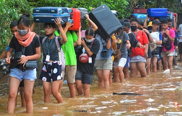Guwahati: Students carry their luggage to safer places after their hostels and accommodations were flooded due to rains, in Guwahati, Wednesday, June 15, 2022. (PTI Photo) 