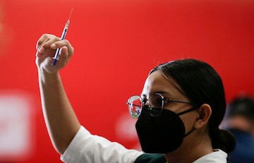 A medical health worker holds up an empty syringe after applies a booster dose of the AstraZeneca coronavirus disease (COVID-19) vaccine (Reuters)