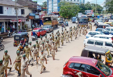 Police personnel conduct a march past in Puttur, Mangaluru on Thursday, July 28, 2022. (PTI Photo)