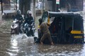 In pics | Heavy rains lead to massive waterlogging in Mumbai, yet life goes on