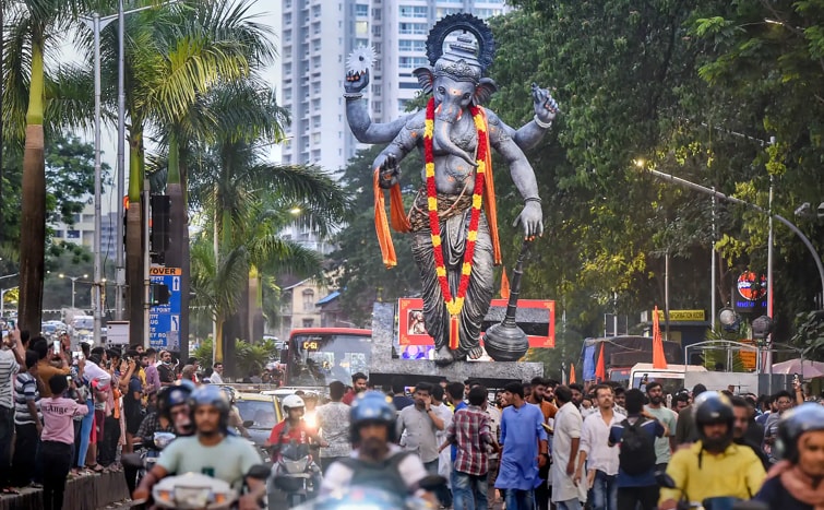 Mumbai: Devotees carry an idol of Lord Ganesh during a procession ahead of the Ganesh Chaturthi festival, in Mumbai, Sunday, Aug. 28, 2022. (PTI Photo/Kunal Patil)(