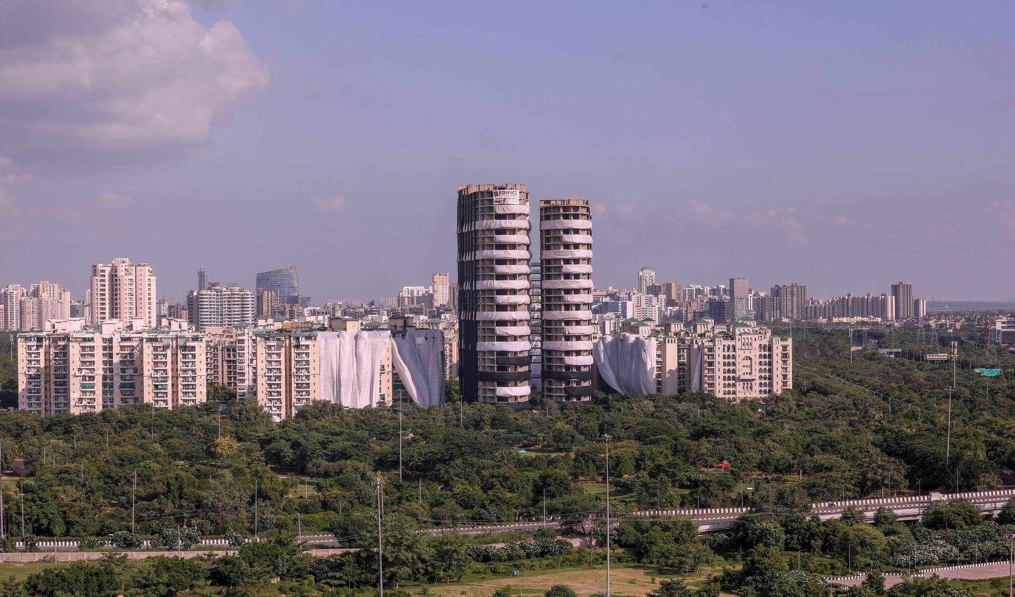 Noida: Buildings of Emerald Court and ATS Village societies, near Supertech's 40-storey twin towers, being covered ahead of the towers' scheduled demolition on Aug. 28, in Noida, Tuesday, Aug. 23, 2022. (PTI Photo)(
