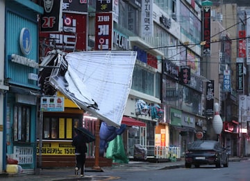 A signboard is seen damaged by Typhoon Hinnamnor in Changwon, South Korea, September 6, 2022. Yonhap/via REUTERS