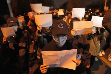 Protesters hold up blank papers and chant slogans as they march in protest in Beijing, Sunday, Nov. 27, 2022. Protesters hold up blank papers and chant slogans as they march in protest in Beijing, Sunday, Nov. 27, 2022. 