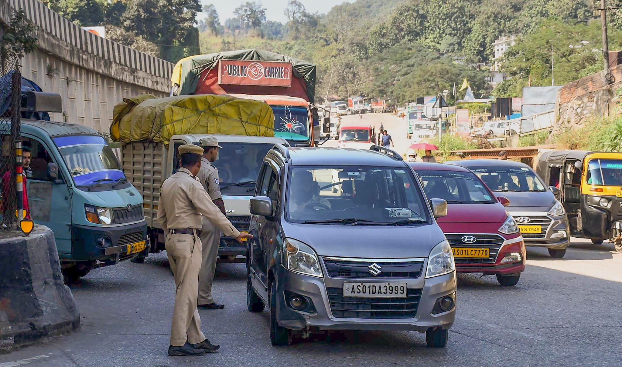 Jorabat: Assam Police personnel stop Meghalaya-bound vehicles for safety reasons, a day after violence at a disputed Assam-Meghalaya border location that killed six people, in Jorabat, Wednesday, Nov. 23, 2022. (PTI Photo)(