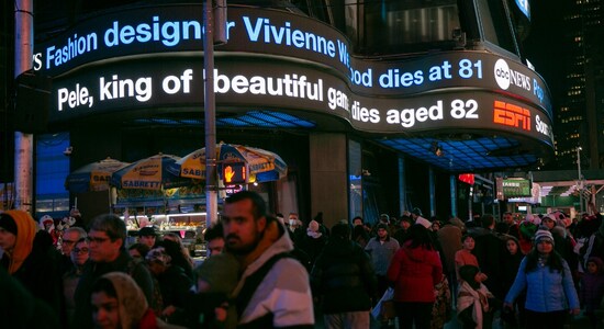 An electric news headline ticker in Times Square, New York, announces the death of soccer legend Pele. (Image: AP) An electric news headline ticker in Times Square, New York, announces the death of soccer legend Pele. (Image: AP)