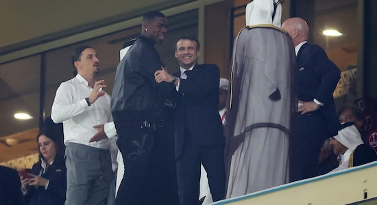 French President Emmanuel Macron shakes hands with Paul Pogba alongside Zlatan Ibrahimovic and FIFA President Gianni Infantino in the stands before the game 