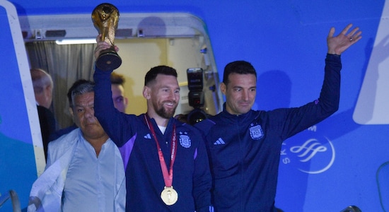 After the plane that carried the team from Qatar to Argentina landed in in Buenos Aires, the first to emerge out of the flight were Lionel Messi and coach Lionel Scaloni. (Image: AP) After the plane that carried the team from Qatar to Argentina landed in in Buenos Aires, the first to emerge out of the flight were Lionel Messi and coach Lionel Scaloni. (Image: AP)