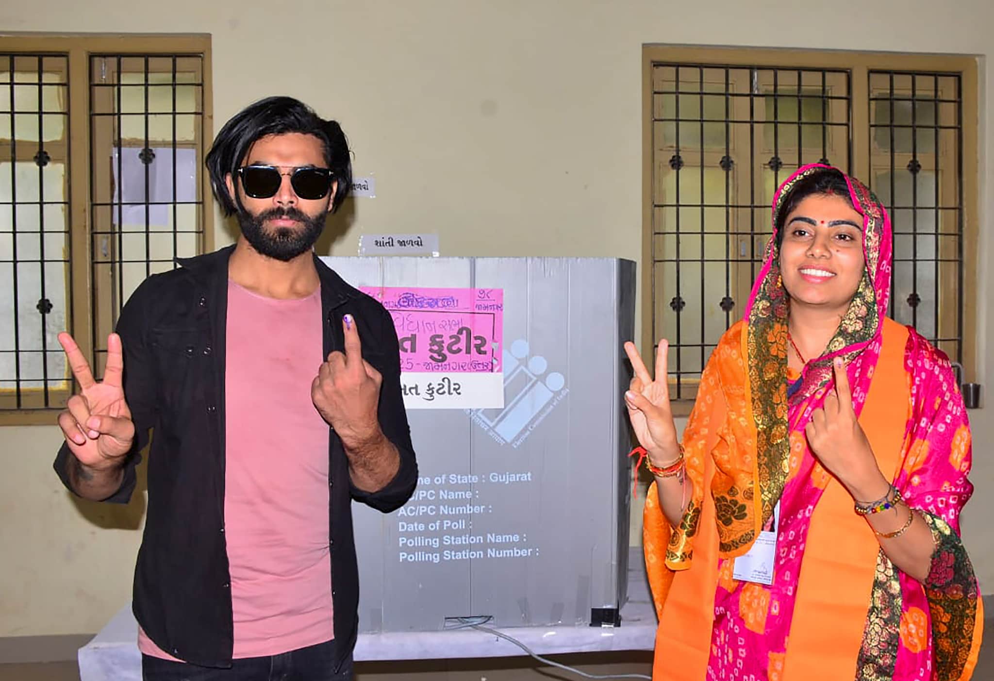 Jamnagar: Cricketer Ravindra Jadeja with his wife and BJP candidate Rivaba Jadeja after casting his vote during the first phase of Gujarat Assembly elections, in Jamnagar, Thursday, Dec. 1, 2022. (PTI Photo)(PTI12_01_2022_000056B)