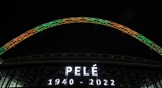 The iconic Wembley Stadium's arch is lit up in the colours of Brazil after it was announced that the former Brazilian footballer Pele had died. (Image: AP)