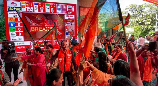 BJP leaders and workers dance as they celebrate the party's decisive lead in Gujarat Assembly elections, in Ahmedabad. (PTI)