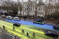 Activists create giant Ukrainian flag outside Russian embassy in London to mark anniversary of invasion